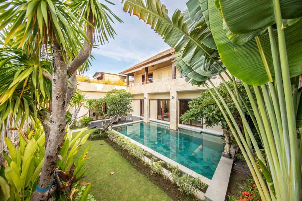 Villa in Bali with palms and nature on the foreground