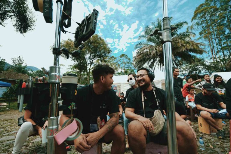 Group of people working on a set of a moovie in Bali