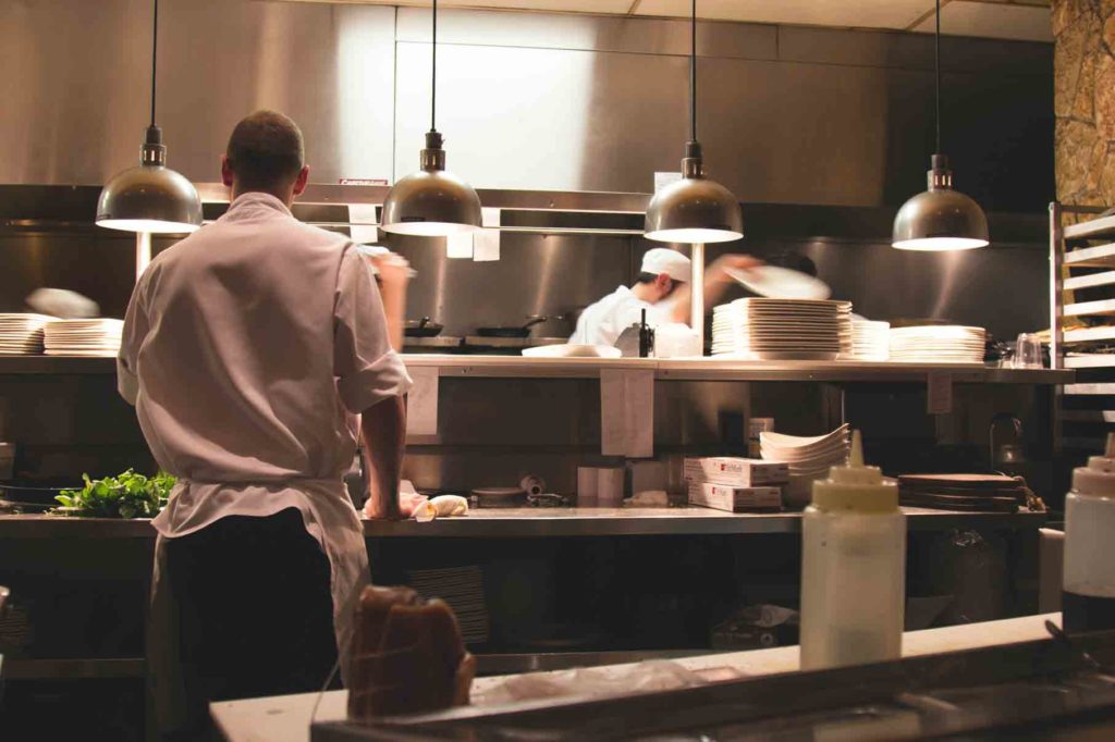 Chef cooking behind the kitchen